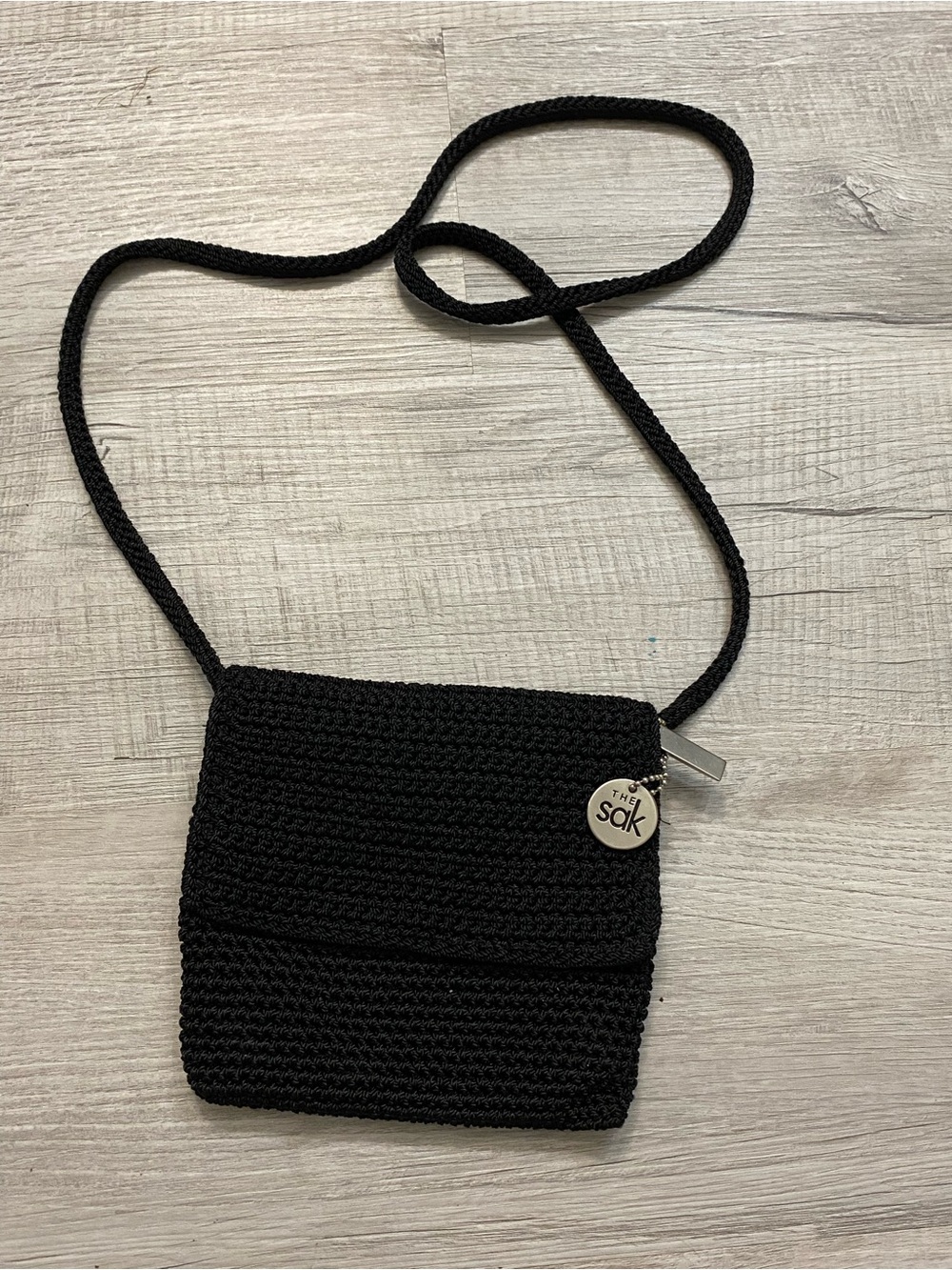 The Sak Black Crochet Crossbody Bag with Logo Charm
